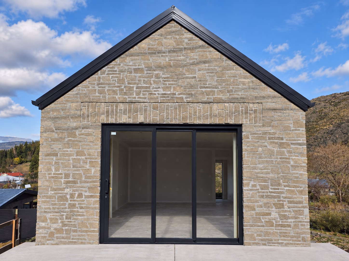 Garage opening framed by Grey Viblock 450 Slim concrete brickwork at Sumner House